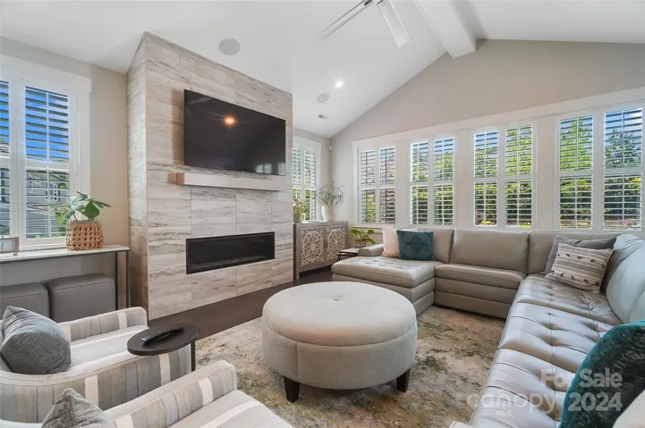 Abundant natural light illuminates the living area, creating a welcoming ambiance, while a cozy gas fireplace adds comfort and charm, perfect for cozying up on chilly evenings.