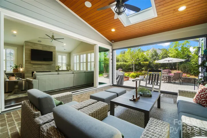 Outdoor Living Room that blends seamlessly with the interior space via stackable sliding doors. Drop down screen encloses for ultimate outdoor living experience.