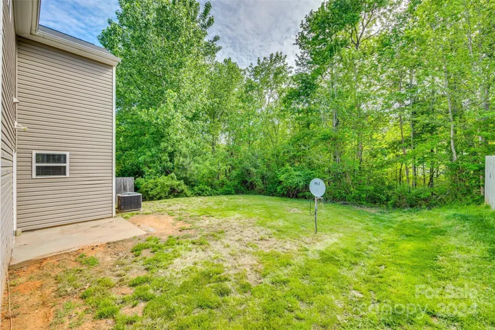 The yard backs up to trees for more privacy!