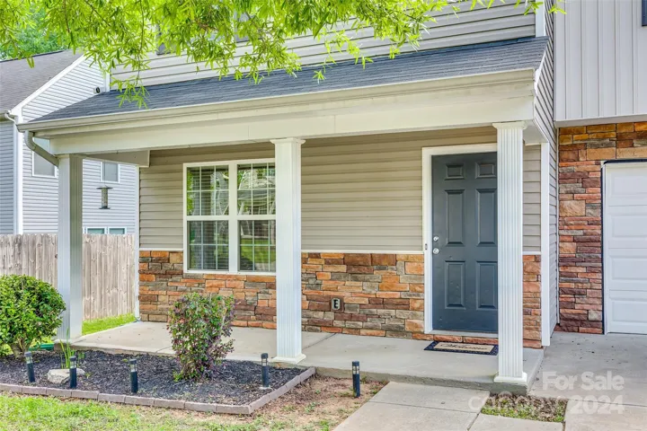 Quaint Covered Front Porch with stone accent.