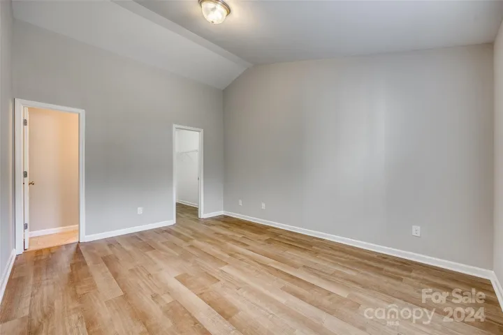 Primary Suite with vaulted ceiling, ensuite bath & walk-in closet.