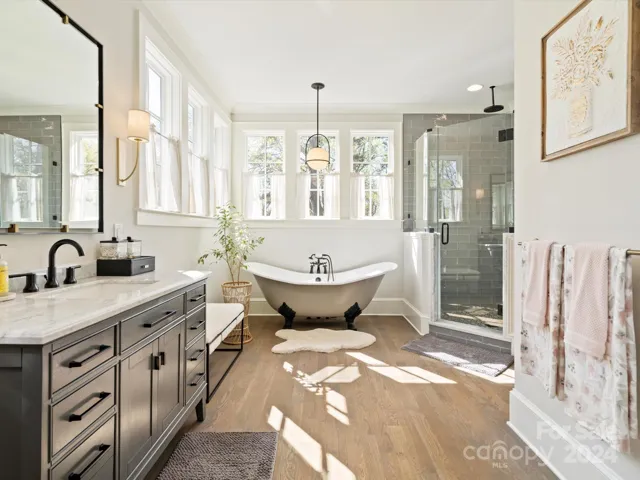 Primary en-suite bath with claw foot soaker tub and full walk-in shower.