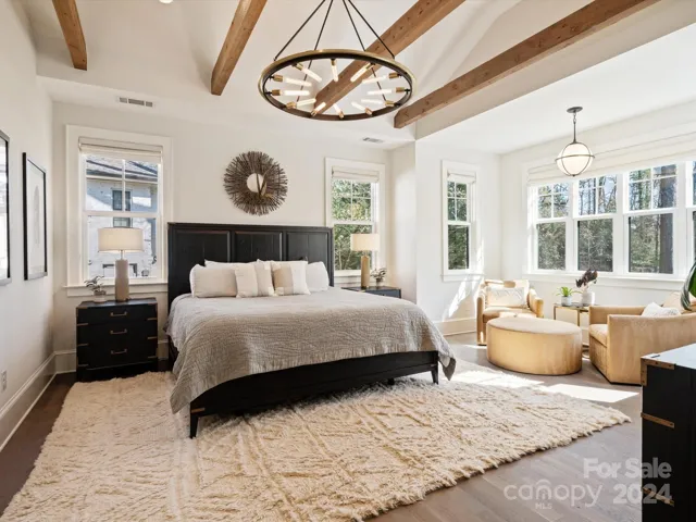 Primary suite with custom wood beams and cathedral cielings.