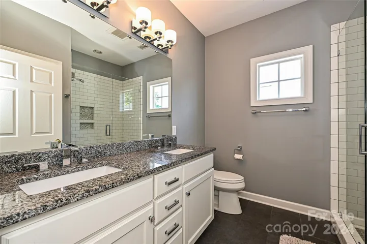 The upstairs Hall Bath also includes modern, updated finishes.