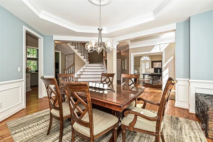 The Dining Room opens to the dramatic foyer and staircase.