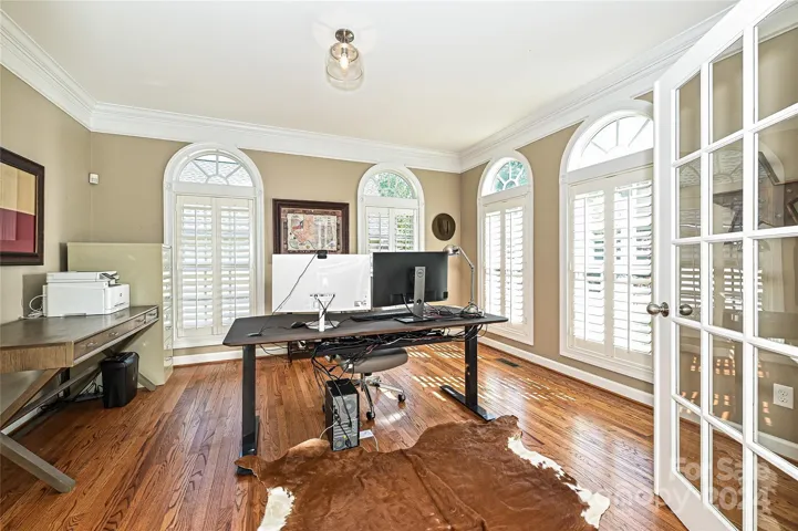 Arched Transom Windows and French Doors will make this study a bright and productive workspace!