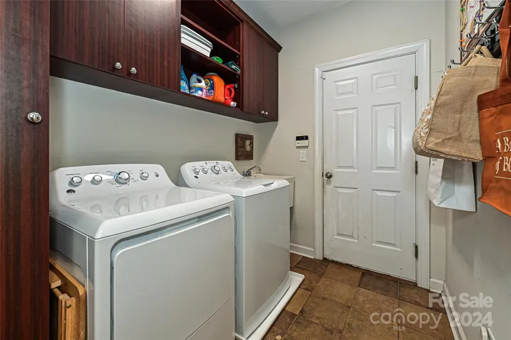 Cabinets and a large sink complete this Mud/ Laundry Room.