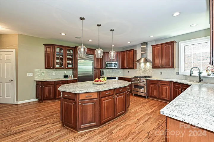 Pendant Lights accentuate the large Island.