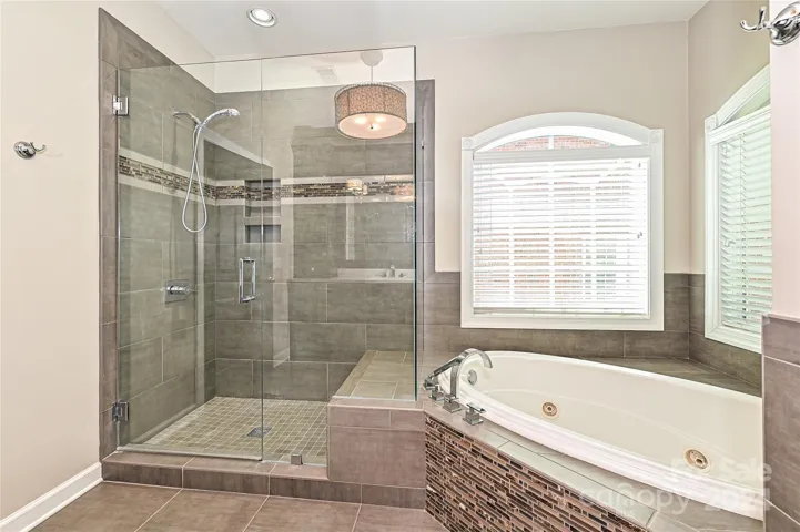 A Frameless Shower, Jaccuzi Tub, and Corner Windows complete Primary Bath #1