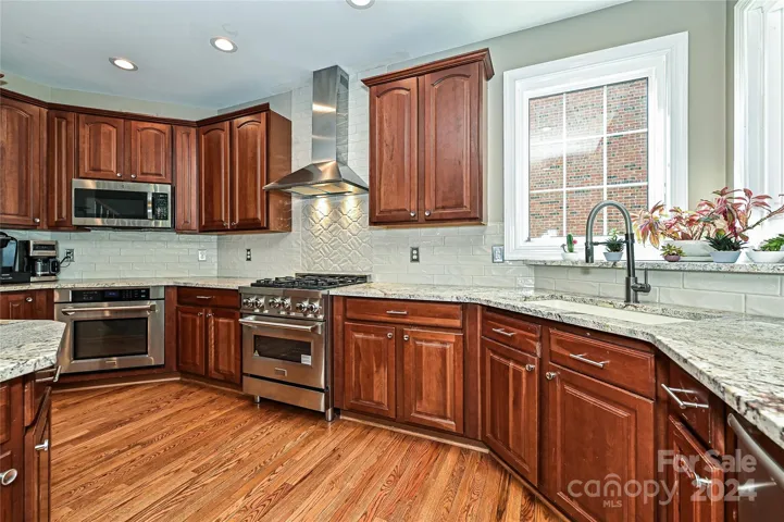 Recently Updated, this Chef's Kitchen features new countertops along with professional appliances and a dual corner window over the sink!