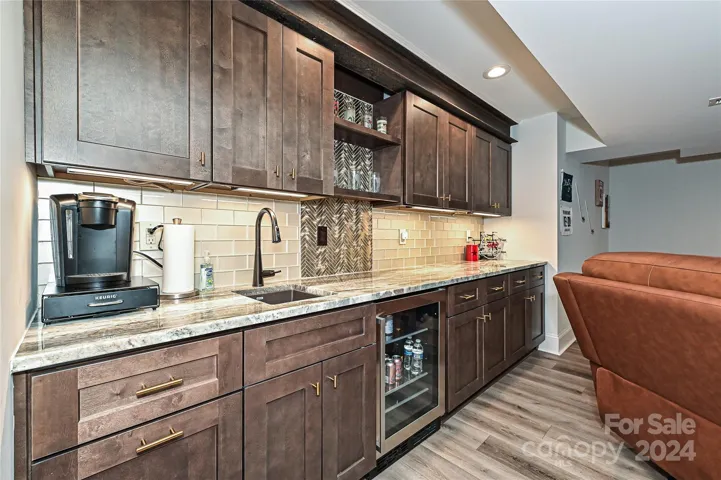 A Wet Bar with Beverage Refrigerator makes entertaining a breeze downstairs!