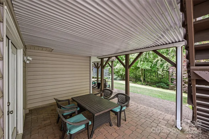 Step out of the Basement Bedrrom and onto the smartly designed Covered Patio where an integrated below-deck drainage system captures & diverts rainwater, providing a perfect spot to unwind outside on a rainy day.