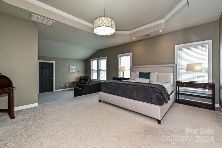 The expanded Primary Suite steps down into a separate seating area.