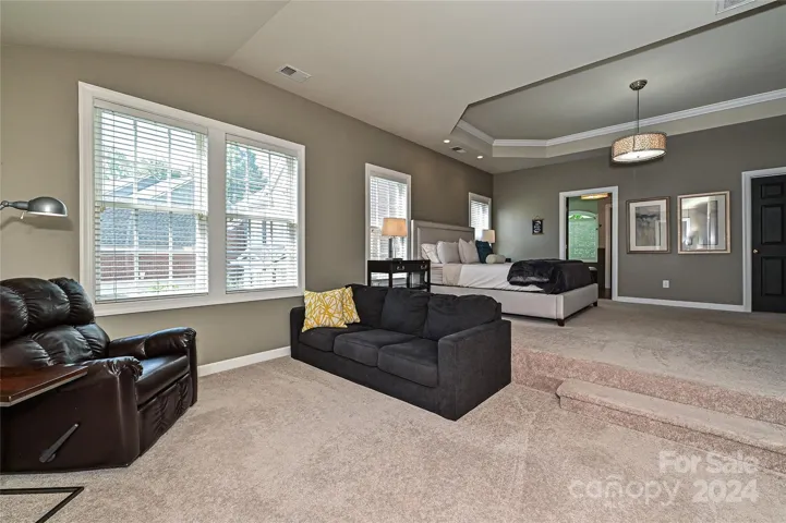The Primary Suite offers tons of natural light through extra windows in the seating area.