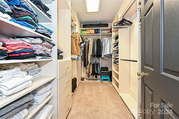Primary Walk In Closet #1 offers plentiful, organized storage.