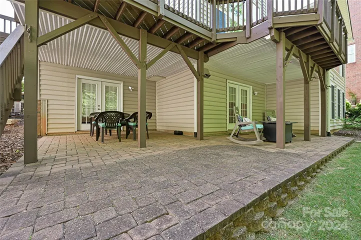 Dual, connected Covered Patios on the Basement Level are protected from Rainwater via integrated below-deck drainage system.
