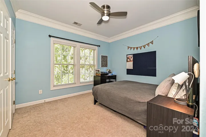 Bedroom 4 offers Crown Molding and plentiful closet space.