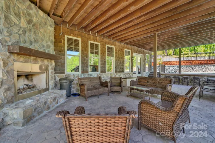 Covered patio, ground level w/ wood-burning fireplace