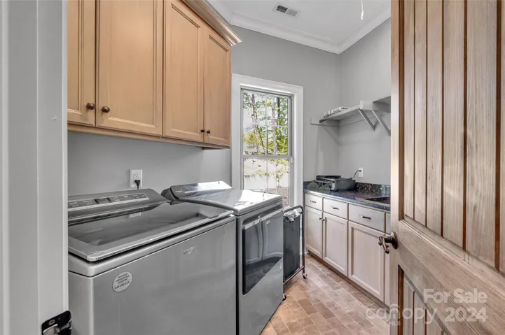 Laundry w/ cabinets, counters and built-in sink