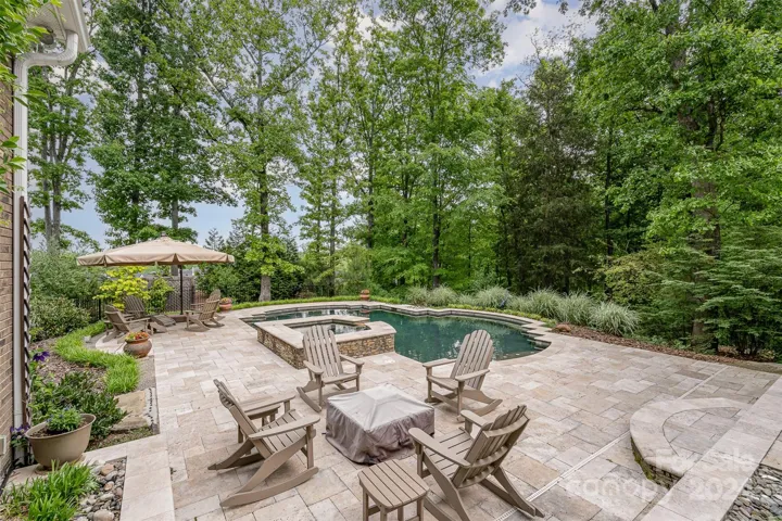 in ground pool with sauna area and tanning ledge
