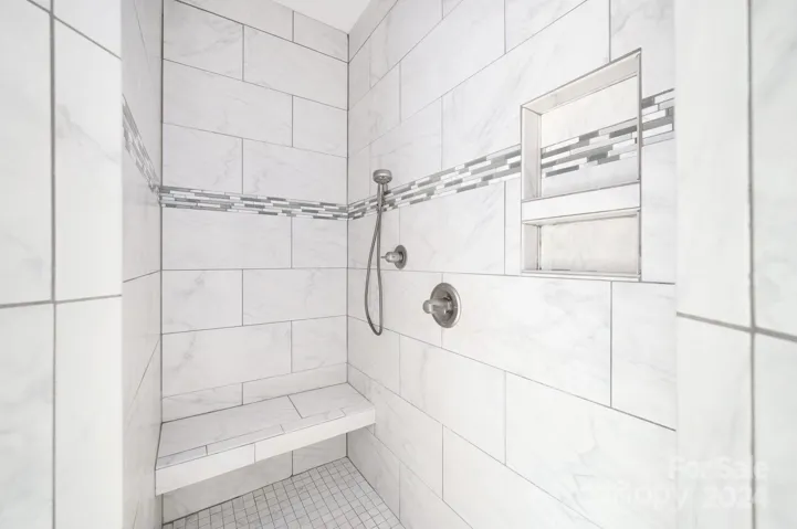 Main-level bedroom ensuite with tiled shower