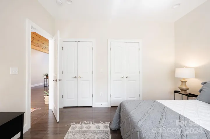 Main-level guest bedroom with double closets and high ceilings