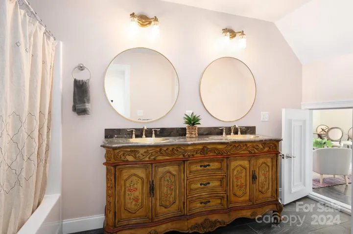 Upper level full bathroom with tub/shower combo and double sink vanity
