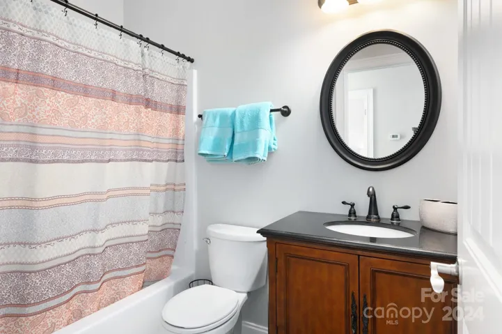 Main-level guest bathroom with tub/shower combo