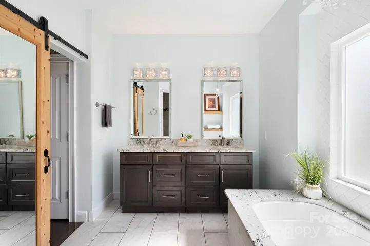 Main-level primary bedroom ensuite with double sink vanity