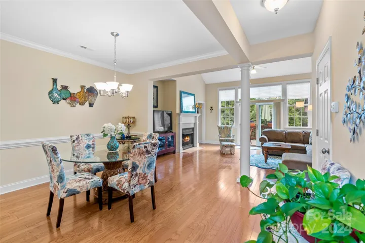 Open concept plan with open formal dining room and gleaming hardwood floors
