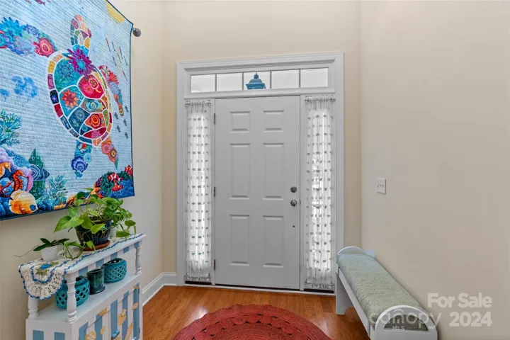 Light and bright foyer entry with hardwood floors
