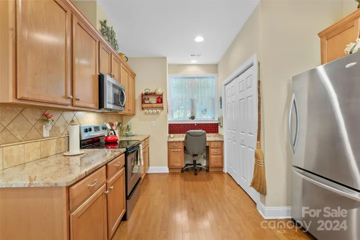 Kitchen has built in desk area plus laundry closet/pantry