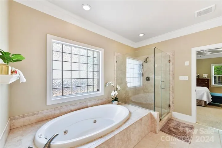 Whirlpool Tub with Tiled Surround and Frameless Shower Door