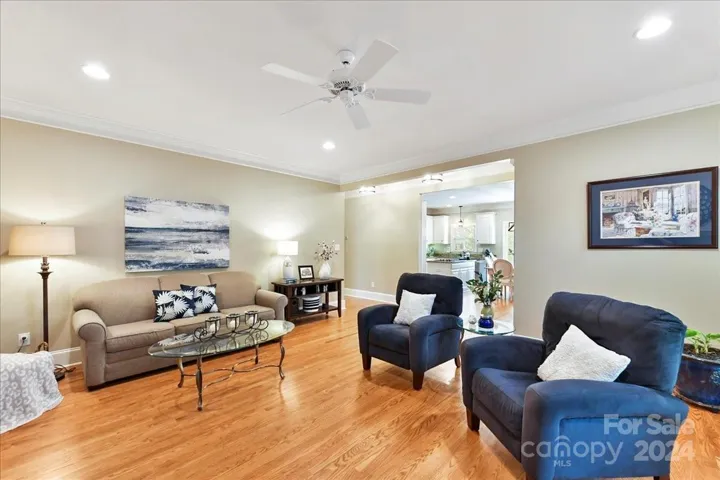 Great Room with Wood Floors, Moldings, Fan and Recessed Canned Lighting