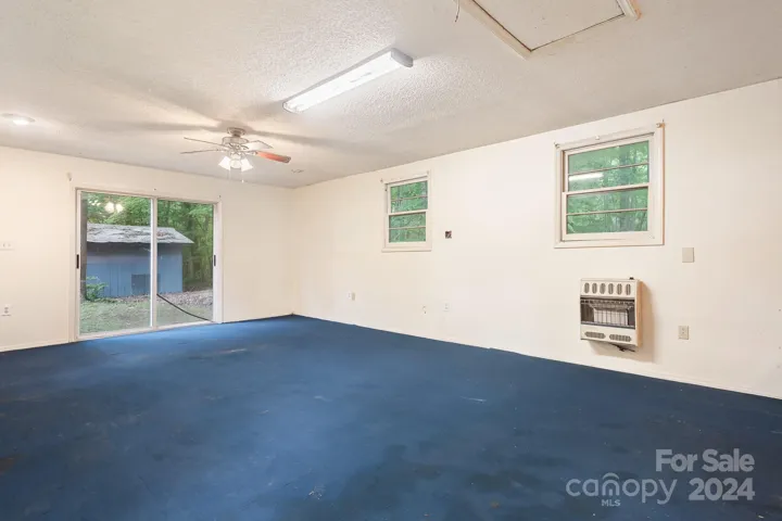 Large Studio living space. Sliding glass doors, Propane Wall Heater.