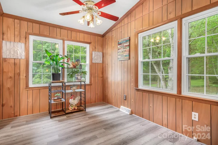 Dining Area with Ceiling fan, large windows and vaulted ceilings