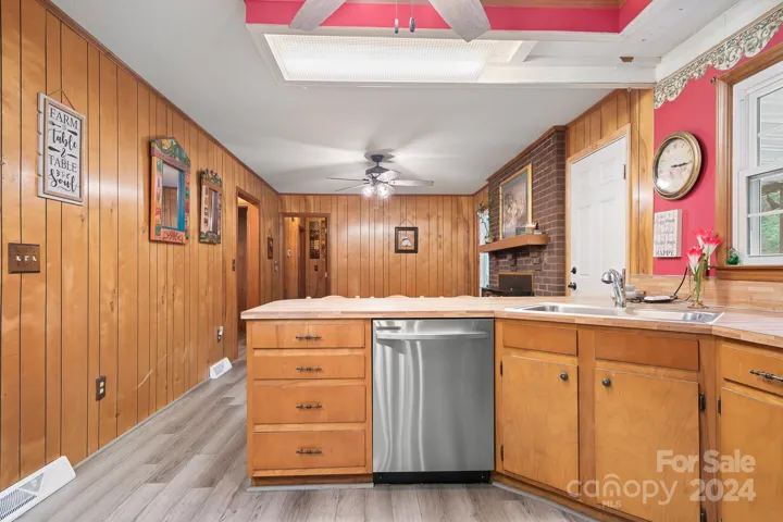 Kitchen area with breakfast counter open to den/family room area.