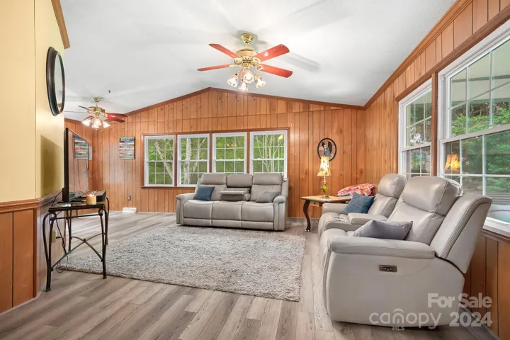 Vaulted Ceilings in Famliyroom area. Ceiling Fan, Large Windows with treed views. NEW LVP Flooring throughout home!
