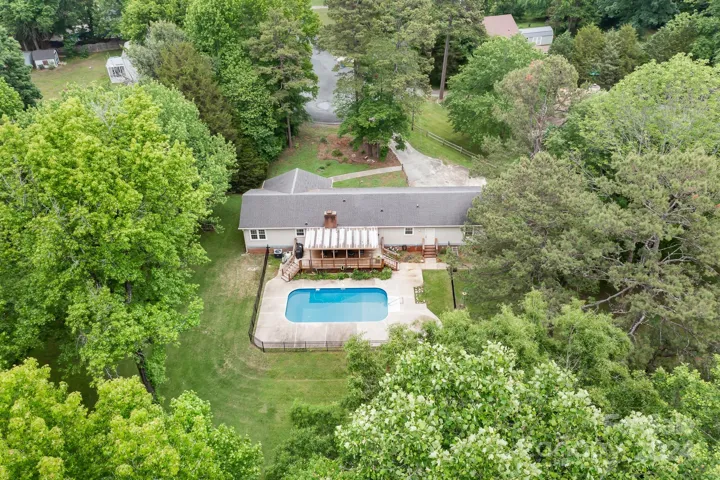 Home in Cul-de-Sac with beautiful pool, covered deck, guest house, and almost 1 acre! Backs to trees!