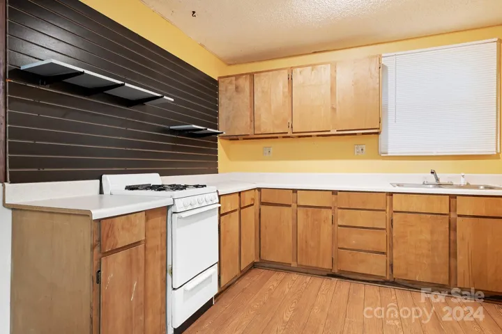 Full Kitchen with Stove, sink and space for Refrigerator. Generous Cabinets and counter space too.