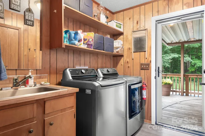 Laundry Room with Washer and Dryer and sink area! Door to back covered deck!
