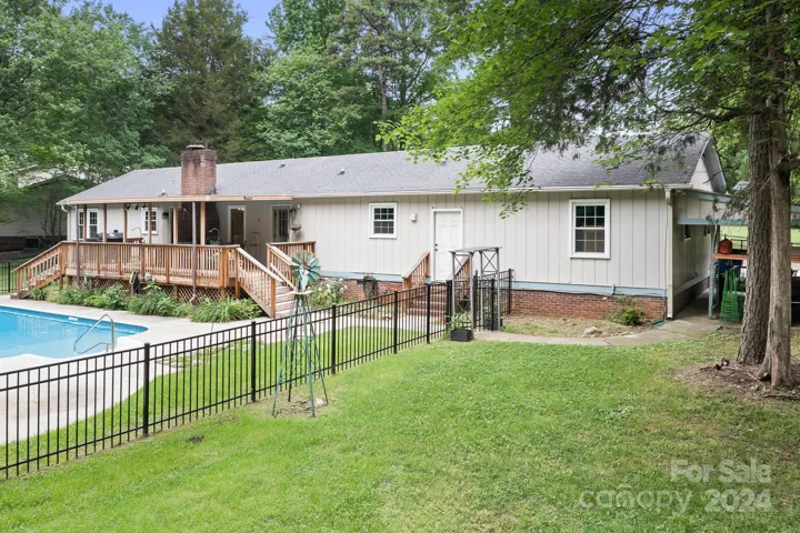 Covered Deck overlooks pool. Iron Fence for pool area