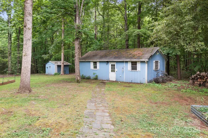 Guest House Studio apartment with large living room/Bedroom area, full kitchen, and full bathroom.  Storage Shed to left