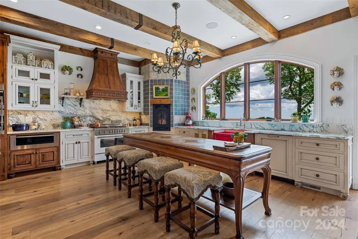 Designer kitchen with custom cabinetry, tile, and Herbeau farmhouse sink.