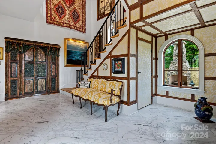 Foyer with Turkish marble floors and grand staircase.