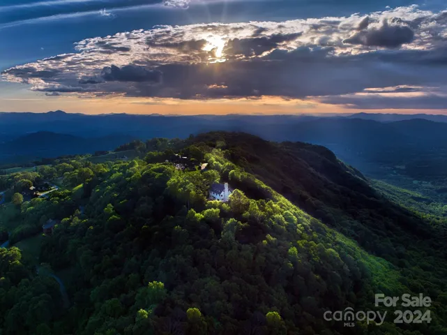 Incredible drone view of the home on the ridge at sunset.