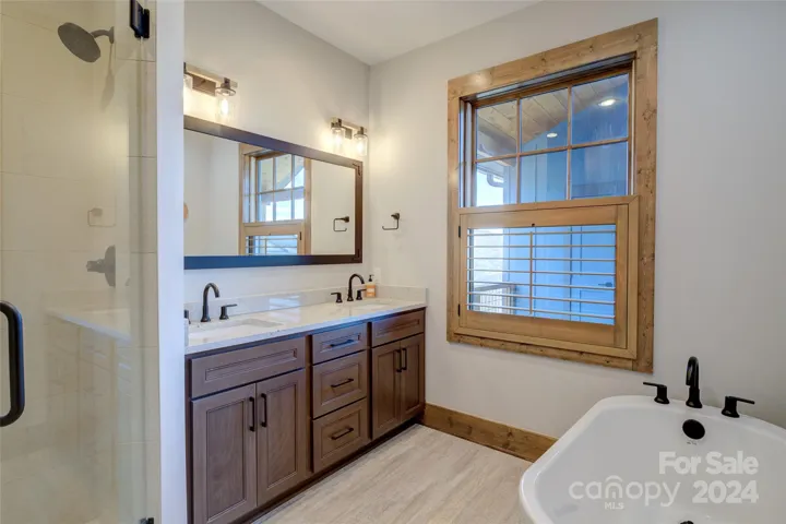 Primary ensuite bath features separate tiled shower, free standing tub, double-vanity & water closet (not pictured)