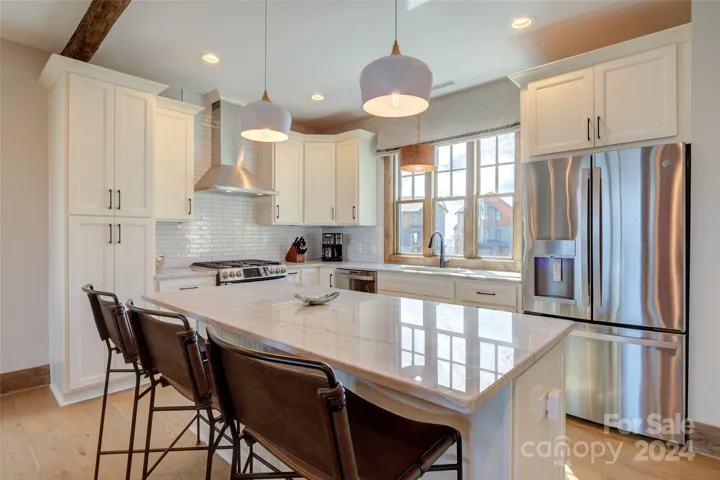 Convenient oversized work island is wide enough to double as a breakfast bar