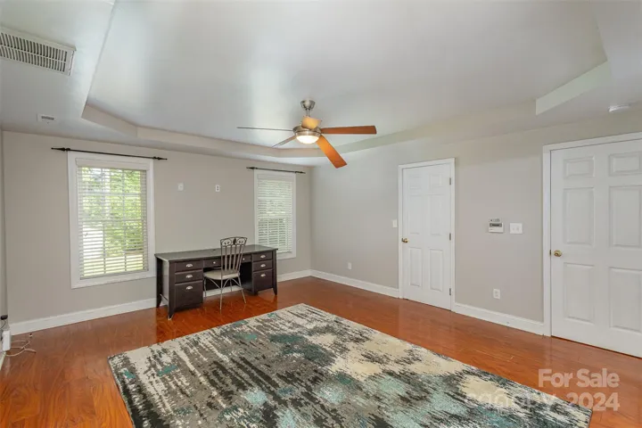 Primary bedroom on the main level with a walk in closet and ensuite bathroom