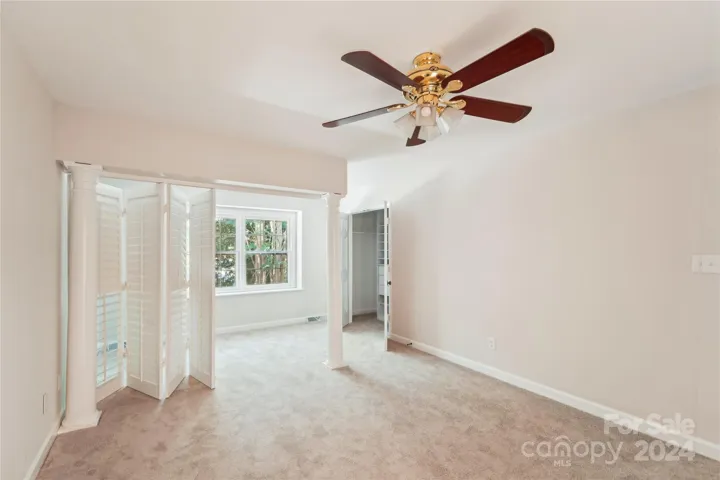 Guest bedroom with view into 2nd closet